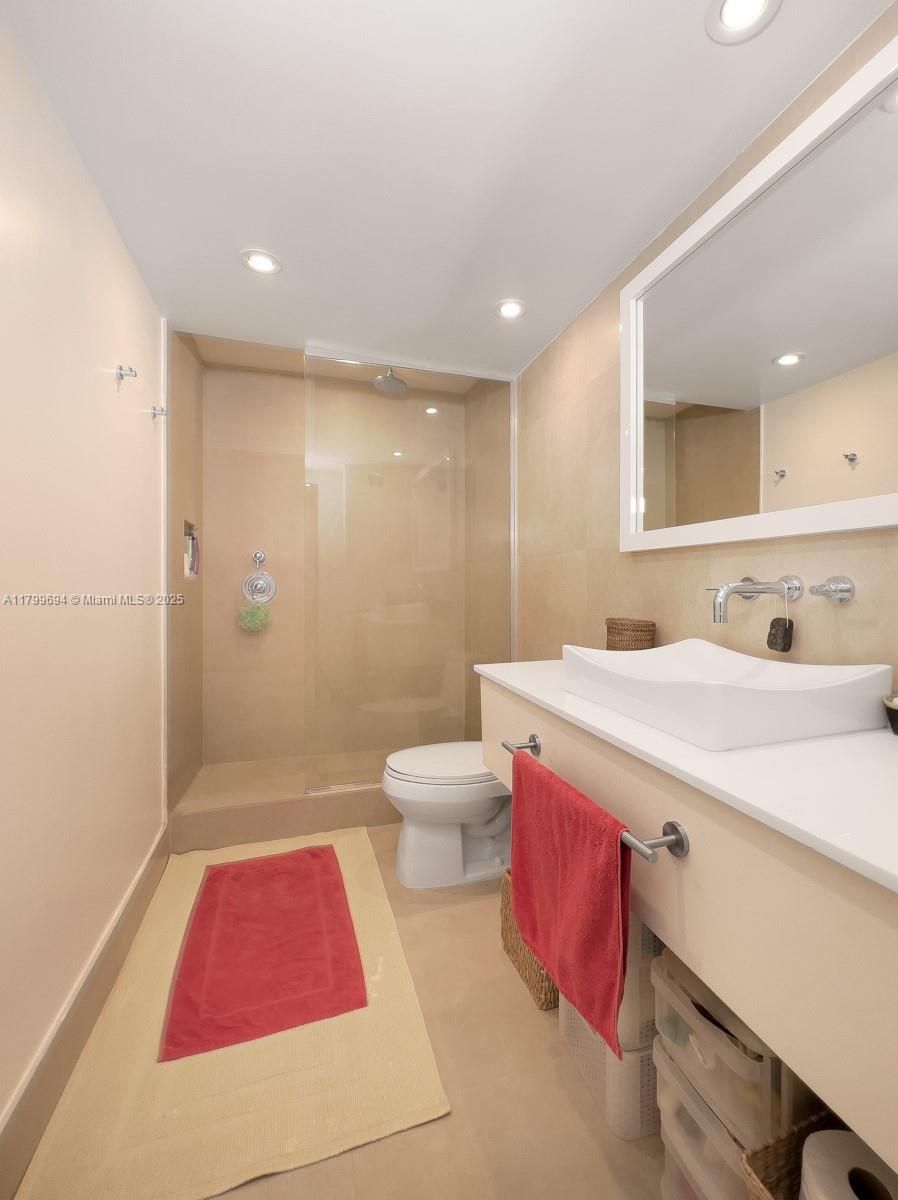 1121 Crandon Boulevard, Unit E307 Key Biscayne, FL 33149 - Photo 10 of 30 a bathroom with a sink and a mirror