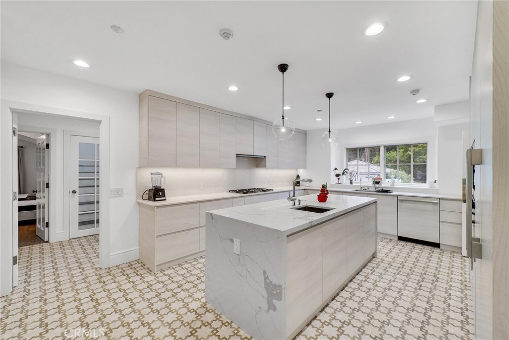 1145 Rancho Road Arcadia, CA 91006 - Photo 14 of 60 a kitchen with white cabinets a sink stove and refrigerator