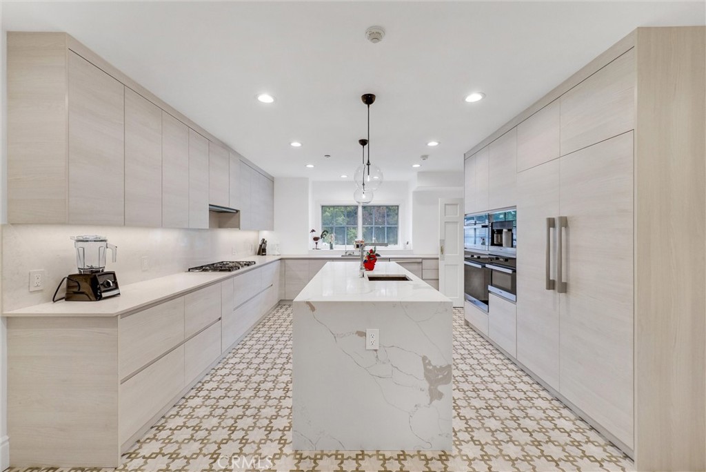 1145 Rancho Road Arcadia, CA 91006 - Photo 15 of 60 a large white kitchen with lots of counter top space a sink stainless steel appliances and cabinets