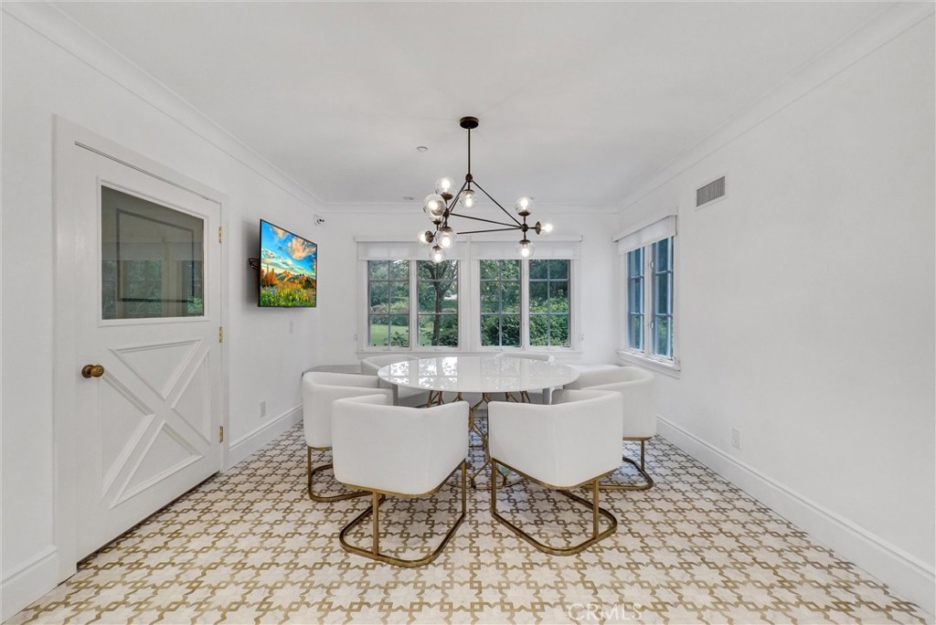 1145 Rancho Road Arcadia, CA 91006 - Photo 18 of 60 a dining room with furniture a chandelier and wooden floor