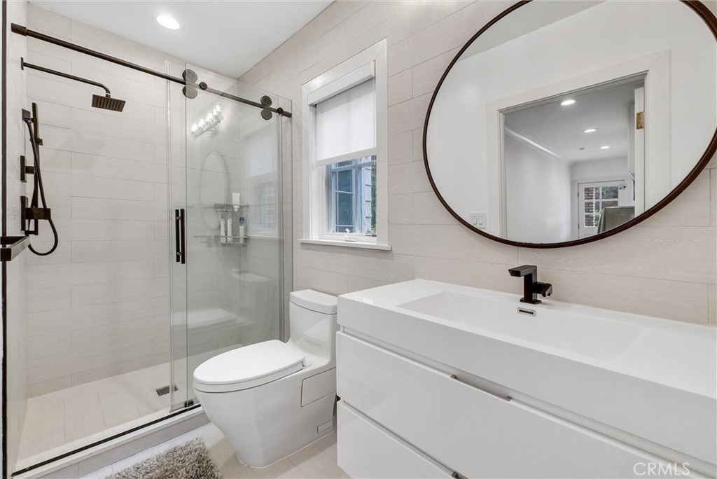 1145 Rancho Road Arcadia, CA 91006 - Photo 30 of 60 a bathroom with a sink a mirror a toilet and shower