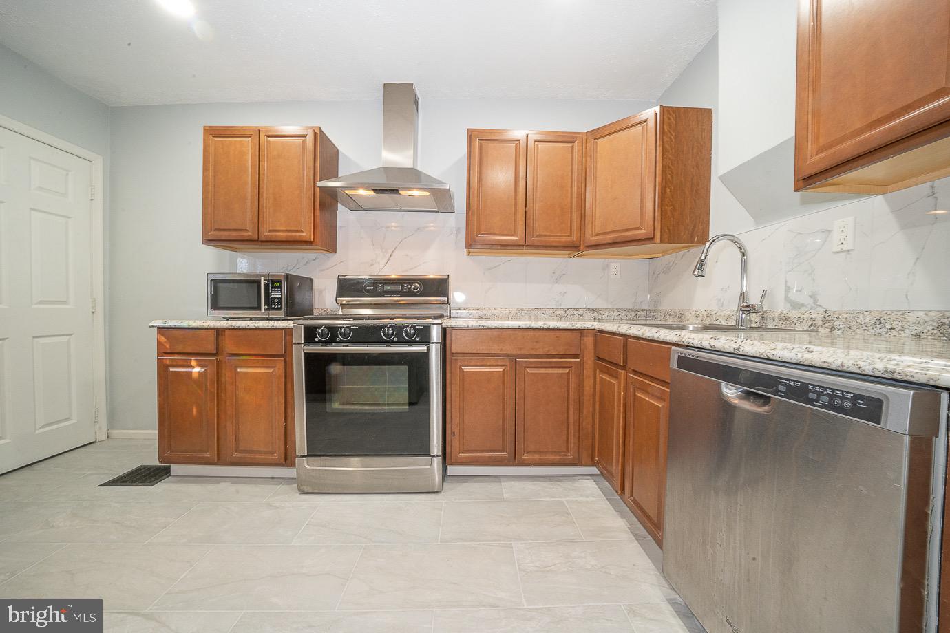 4522 Smick Street Philadelphia, PA 19127 - Photo 13 of 36 a kitchen with a stove sink and cabinets