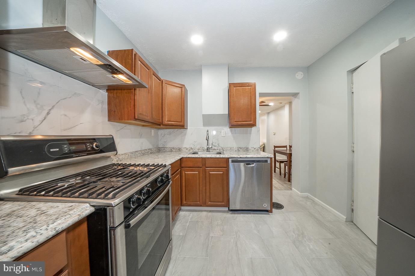 4522 Smick Street Philadelphia, PA 19127 - Photo 14 of 36 a kitchen with stainless steel appliances granite countertop a stove a sink and a microwave