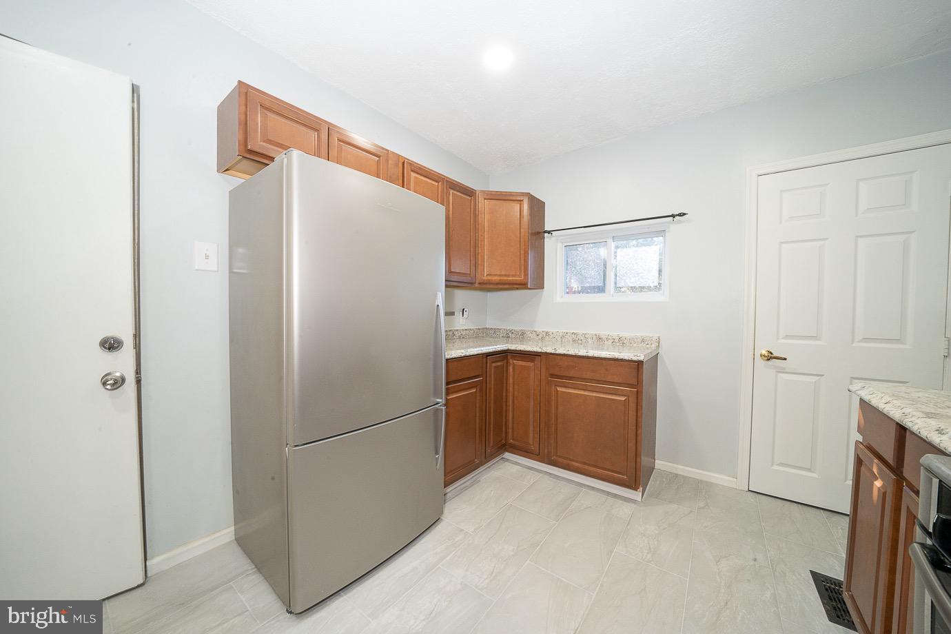 4522 Smick Street Philadelphia, PA 19127 - Photo 15 of 36 a kitchen with stainless steel appliances granite countertop a refrigerator and a stove top oven