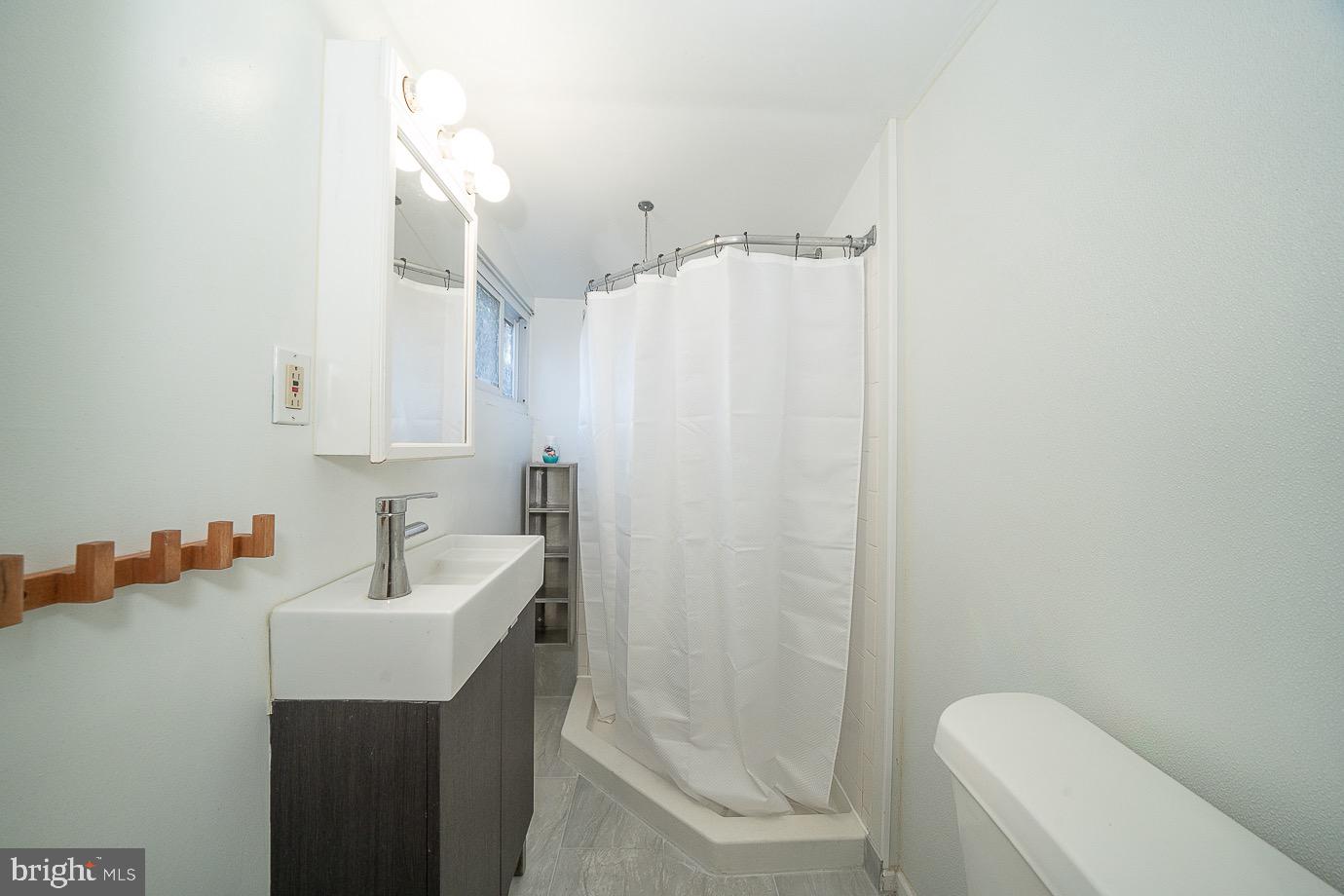 4522 Smick Street Philadelphia, PA 19127 - Photo 17 of 36 a bathroom with a sink a toilet and shower