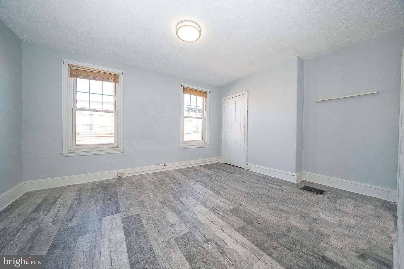 4522 Smick Street Philadelphia, PA 19127 - Photo 24 of 36 an empty room with wooden floor and windows