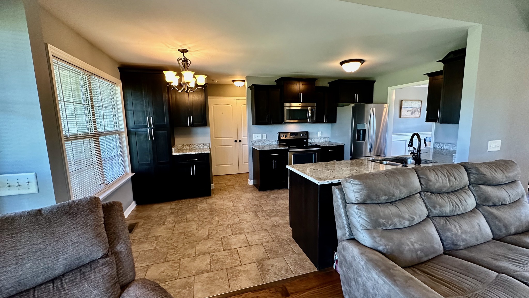 509 Neal Road Watertown, TN 37184 - Photo 21 of 48 a kitchen with stainless steel appliances kitchen island granite countertop a refrigerator a stove a sink and a dining table with wooden floor
