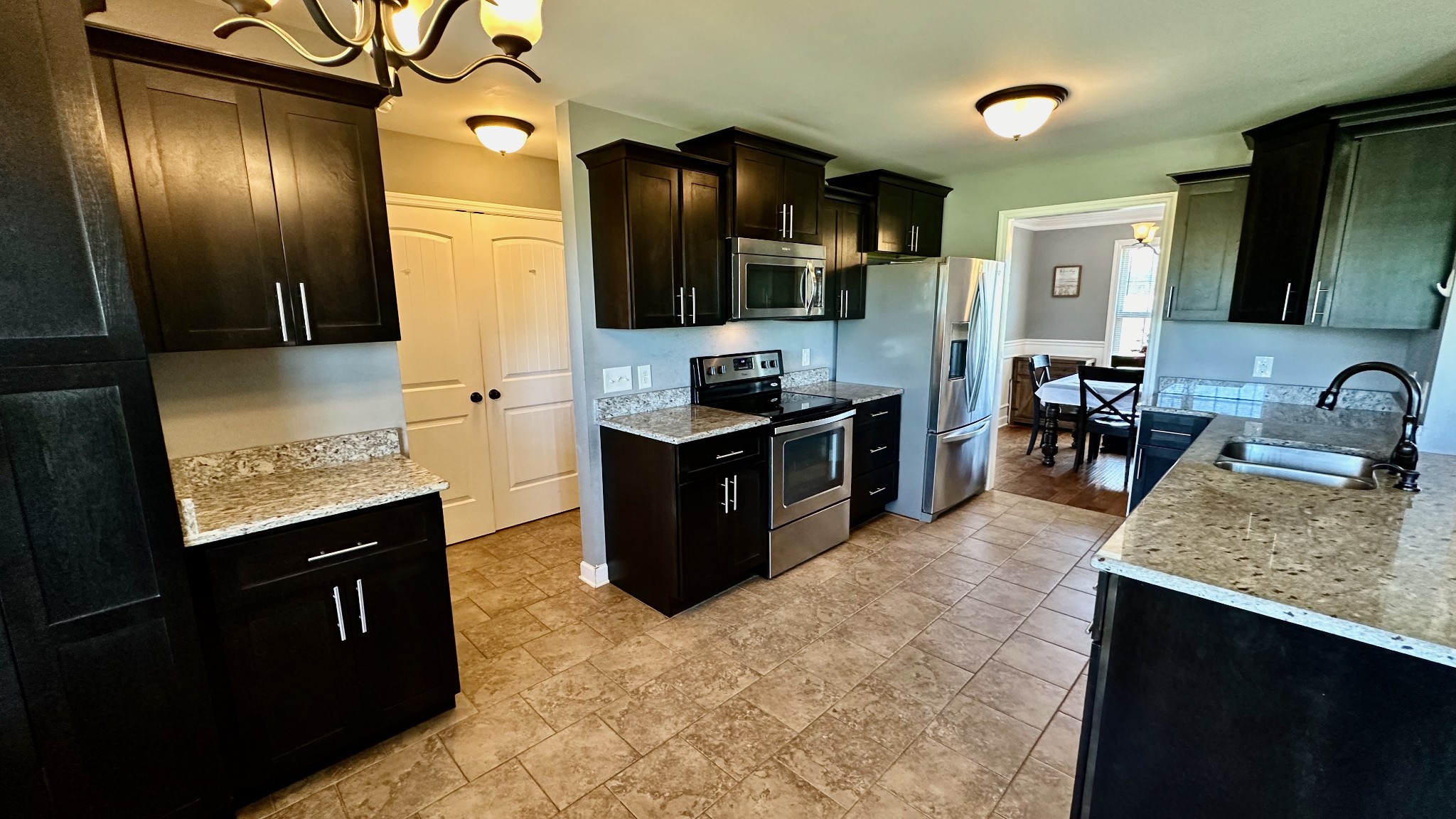 509 Neal Road Watertown, TN 37184 - Photo 23 of 48 a kitchen with stainless steel appliances granite countertop a sink stove and refrigerator
