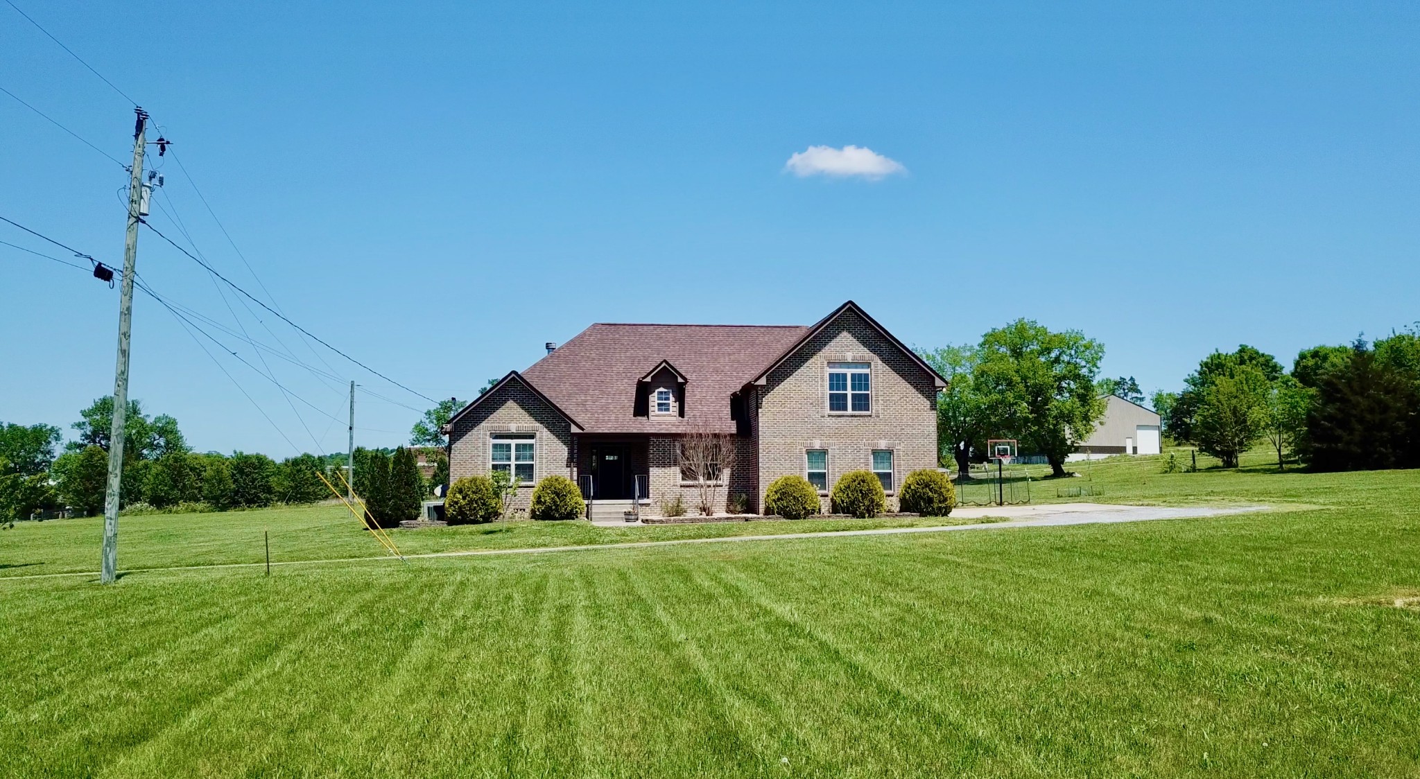 509 Neal Road Watertown, TN 37184 - Photo 3 of 48 a front view of a house with a yard and trees