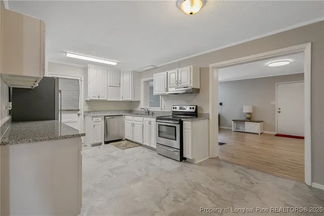 a kitchen with stainless steel appliances granite countertop a refrigerator sink and cabinets