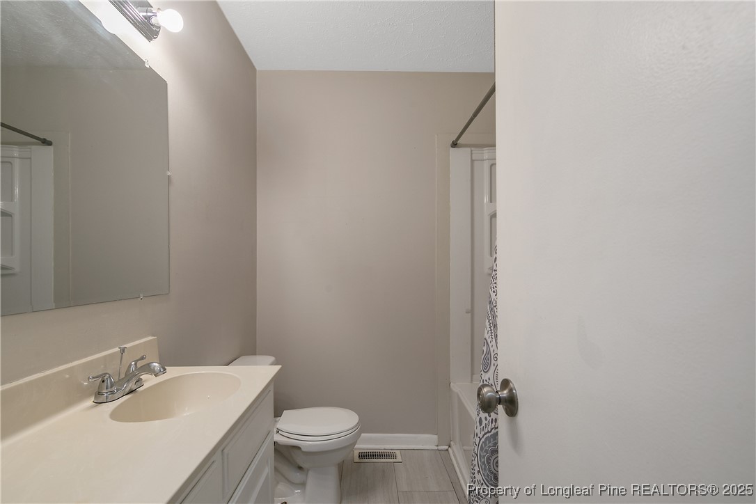 4914 Pinewood Drive Hope Mills, NC 28348 - Photo 23 of 36 a bathroom with a sink and toilet