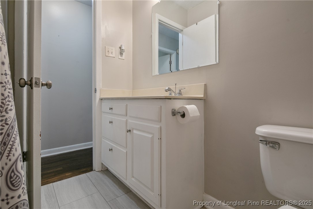 4914 Pinewood Drive Hope Mills, NC 28348 - Photo 24 of 36 a bathroom with a sink a toilet and a mirror