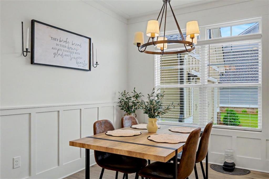 943 Clubside Drive Monroe, GA 30655 - Photo 20 of 93 a view of a dining room with furniture window and wooden floor