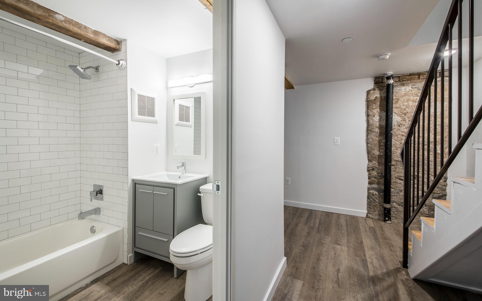 1201 Jackson Street, Unit 516 Philadelphia, PA 19148 - Photo 36 of 42 a bathroom with a sink toilet and shower