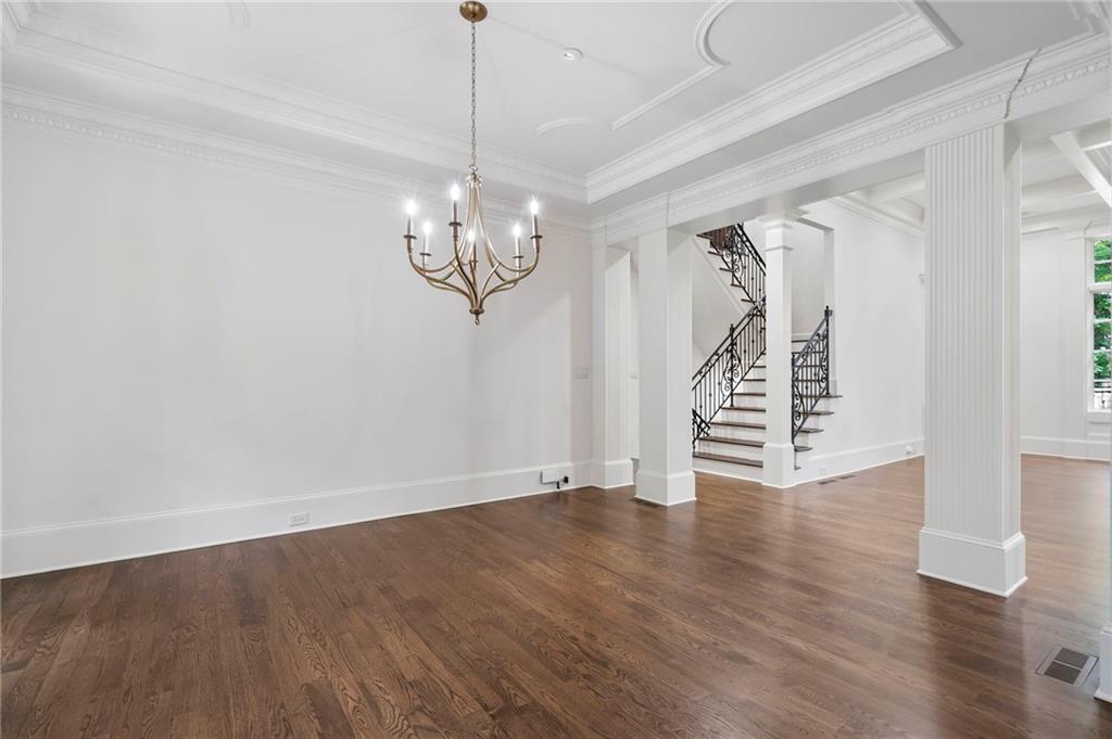 989 Middle Fork Trail Suwanee, GA 30024 - Photo 14 of 76 a view of an empty room with wooden floor closet and a window