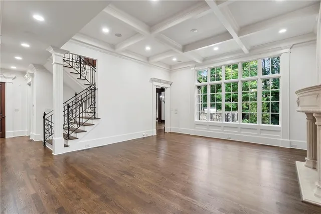 a kitchen with kitchen island granite countertop a stove and a wooden floors