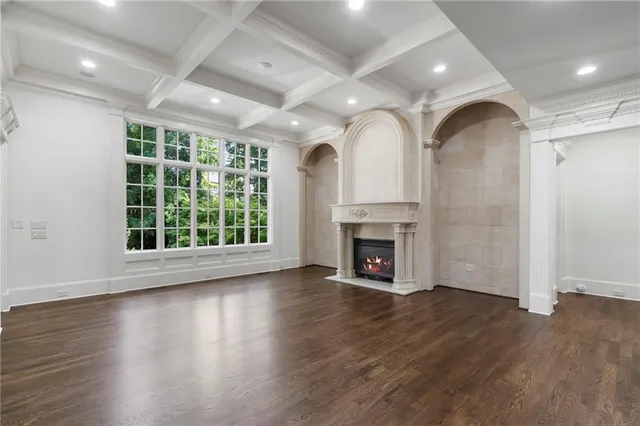 a living room with a fireplace a flat screen tv and a fireplace
