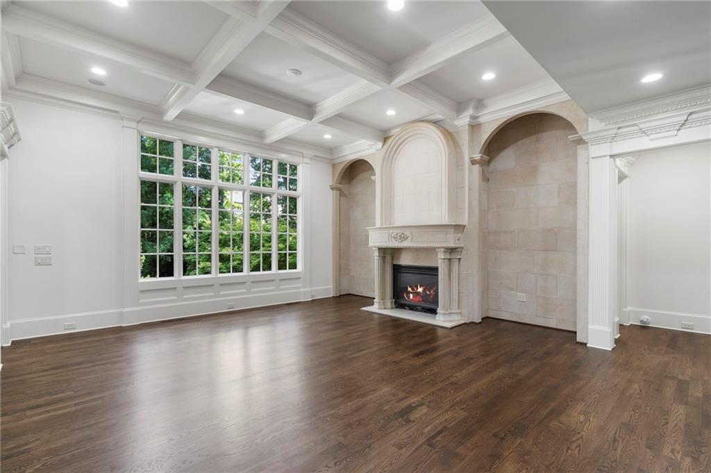 989 Middle Fork Trail Suwanee, GA 30024 - Photo 17 of 76 an empty room with wooden floor fireplace and windows