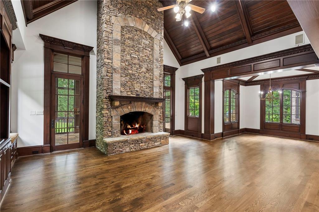 989 Middle Fork Trail Suwanee, GA 30024 - Photo 27 of 76 a view of an empty room with wooden floor fireplace and a window