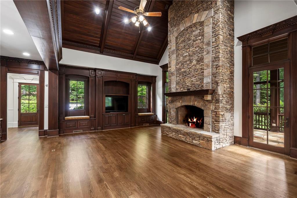 989 Middle Fork Trail Suwanee, GA 30024 - Photo 28 of 76 a view of a livingroom with wooden floor and a fireplace