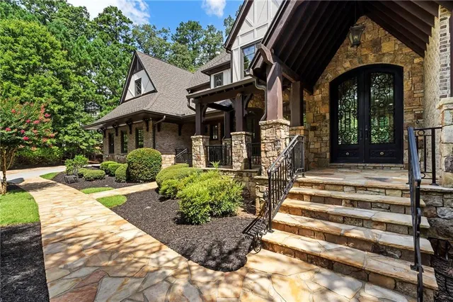 an aerial view of a house with a yard and trees