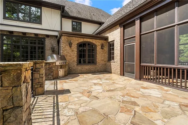 a view of hallway with wooden floor and pendant lights