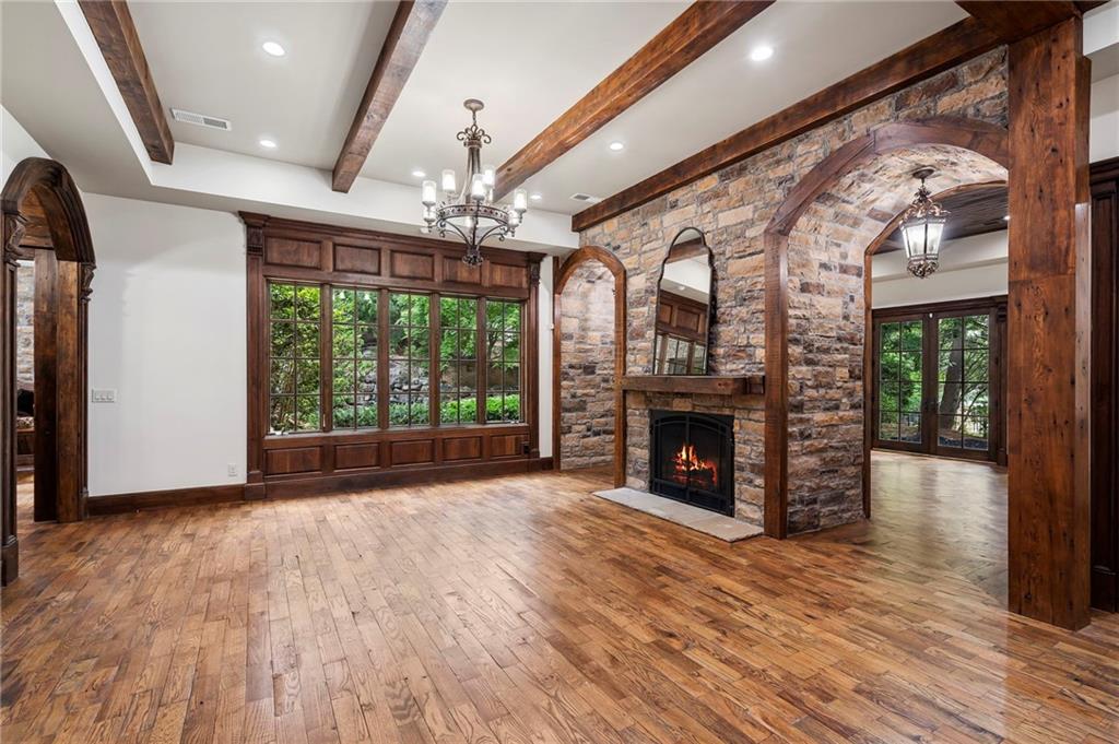 989 Middle Fork Trail Suwanee, GA 30024 - Photo 34 of 76 a view of an empty room with wooden floor fireplace and a window