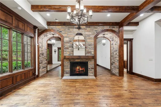 a spacious bathroom with a granite countertop sink a mirror and shower