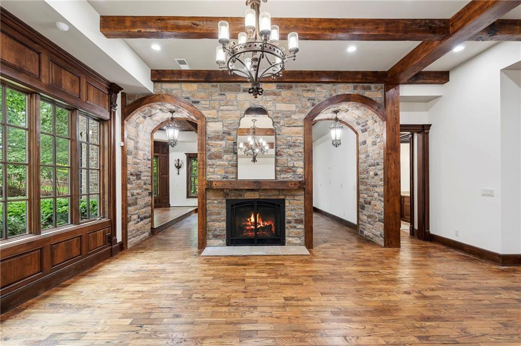 989 Middle Fork Trail Suwanee, GA 30024 - Photo 35 of 76 a view of an empty room with wooden floor fan and windows