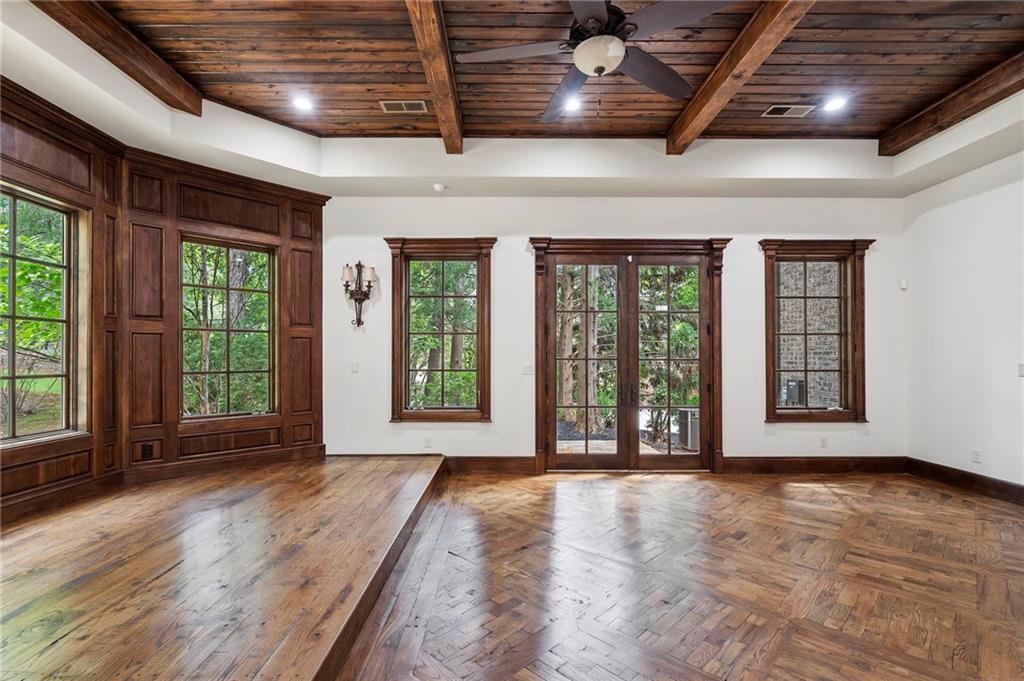 989 Middle Fork Trail Suwanee, GA 30024 - Photo 39 of 76 a view of an empty room with wooden floor and a window