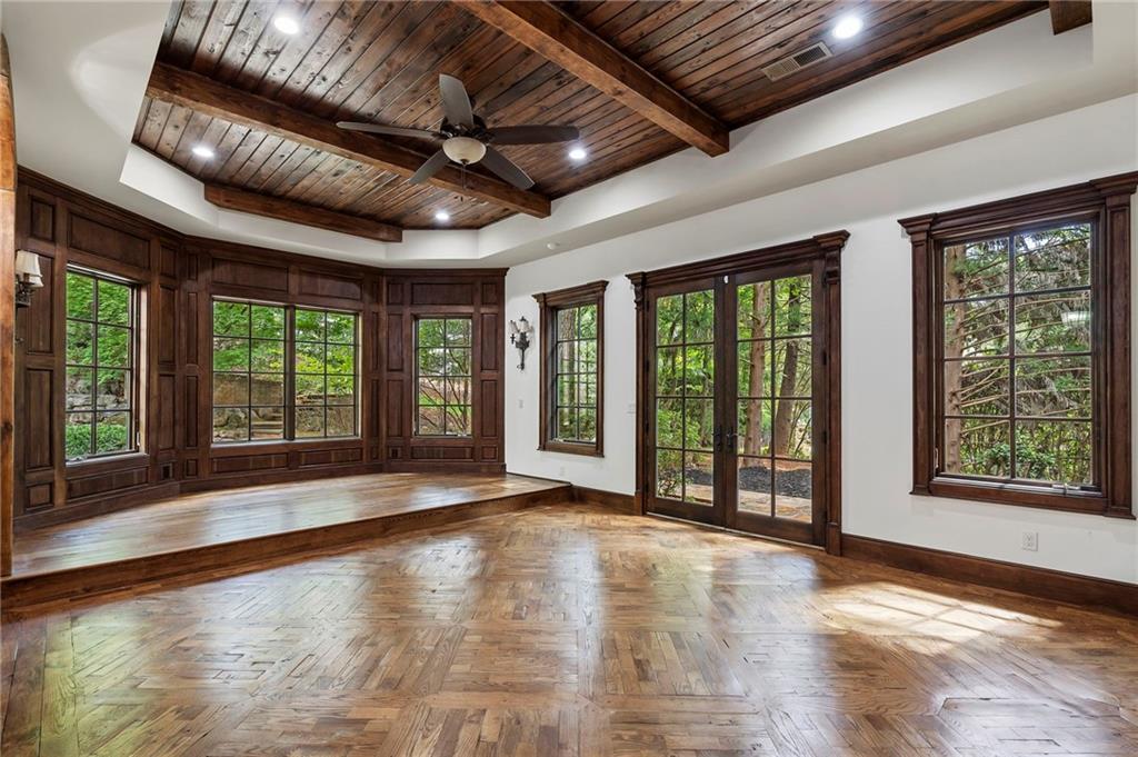 989 Middle Fork Trail Suwanee, GA 30024 - Photo 40 of 76 a view of an empty room with wooden floor and a window