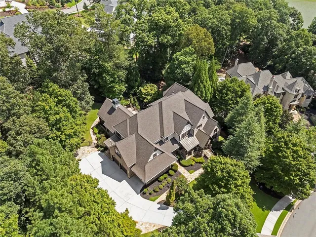 a view of a dining room with furniture a chandelier and wooden floor