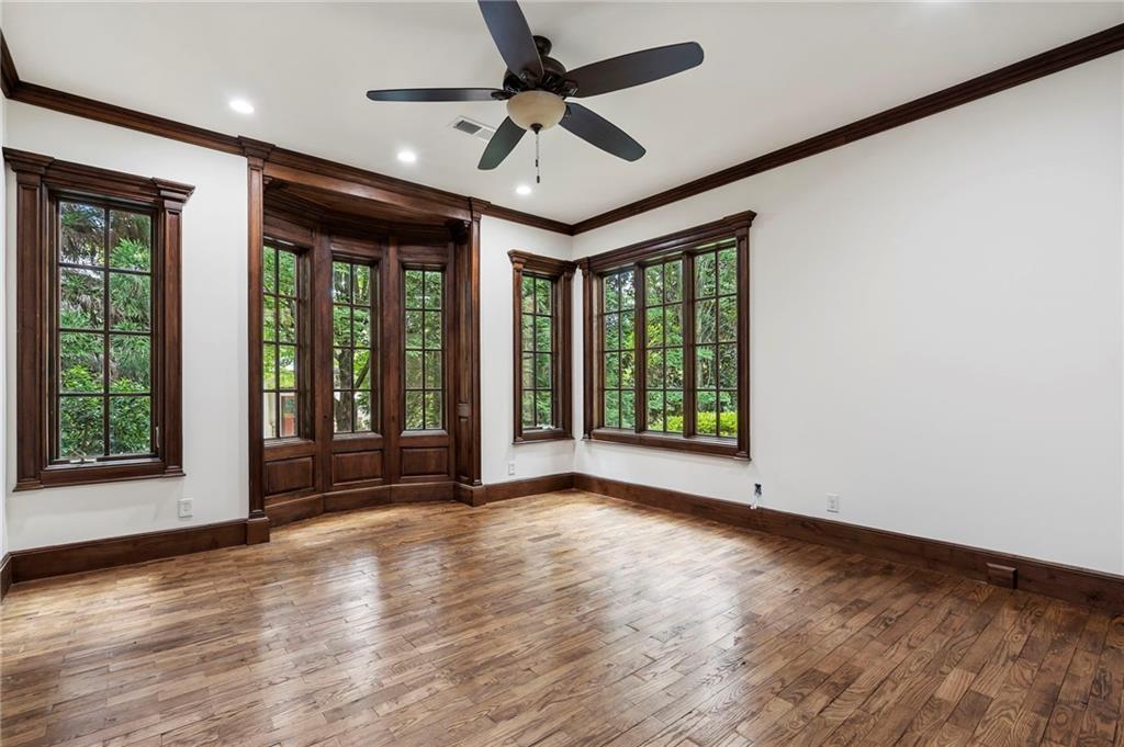 989 Middle Fork Trail Suwanee, GA 30024 - Photo 41 of 76 a view of an empty room with a window and wooden floor