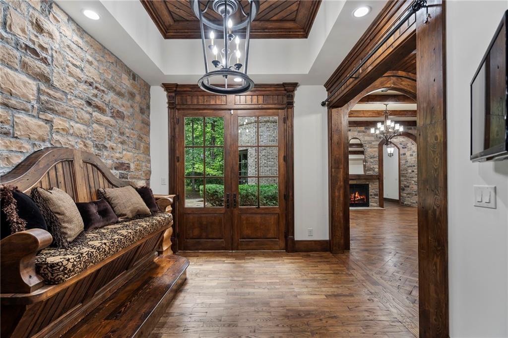 989 Middle Fork Trail Suwanee, GA 30024 - Photo 44 of 76 a living room with furniture and a chandelier