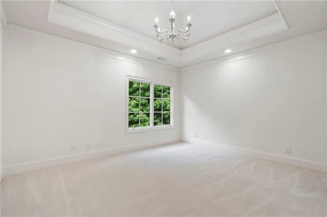 a living room with furniture a large window and chandelier