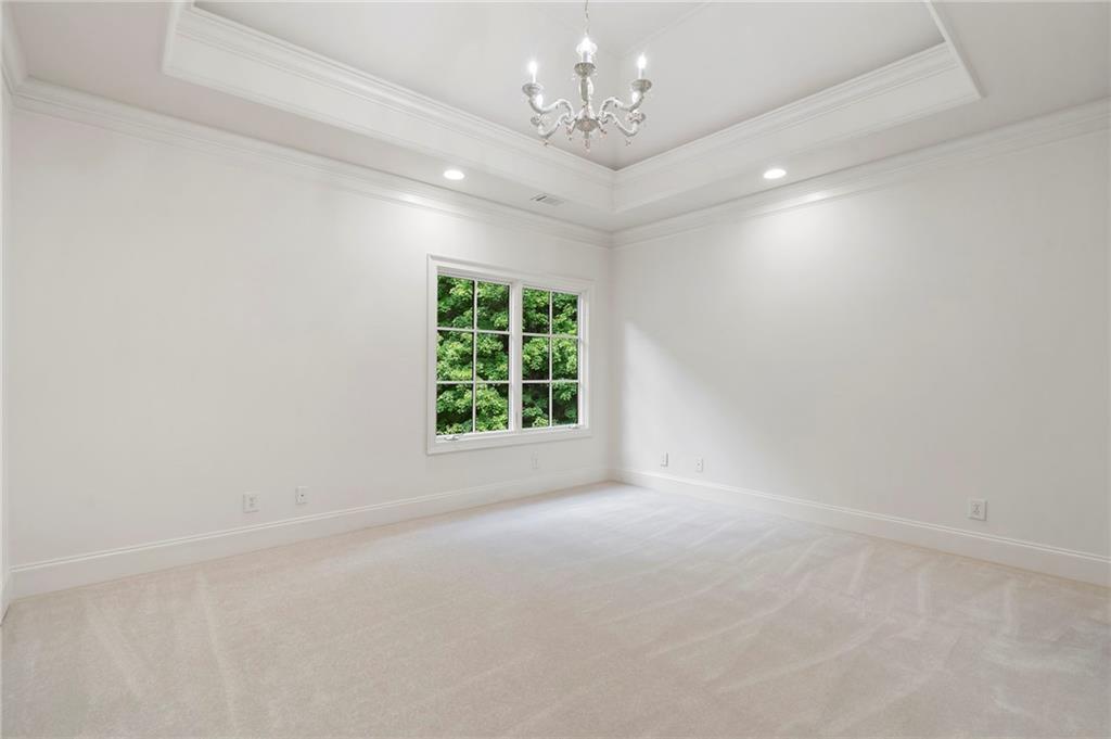 989 Middle Fork Trail Suwanee, GA 30024 - Photo 46 of 76 en empty room with windows and chandelier fan