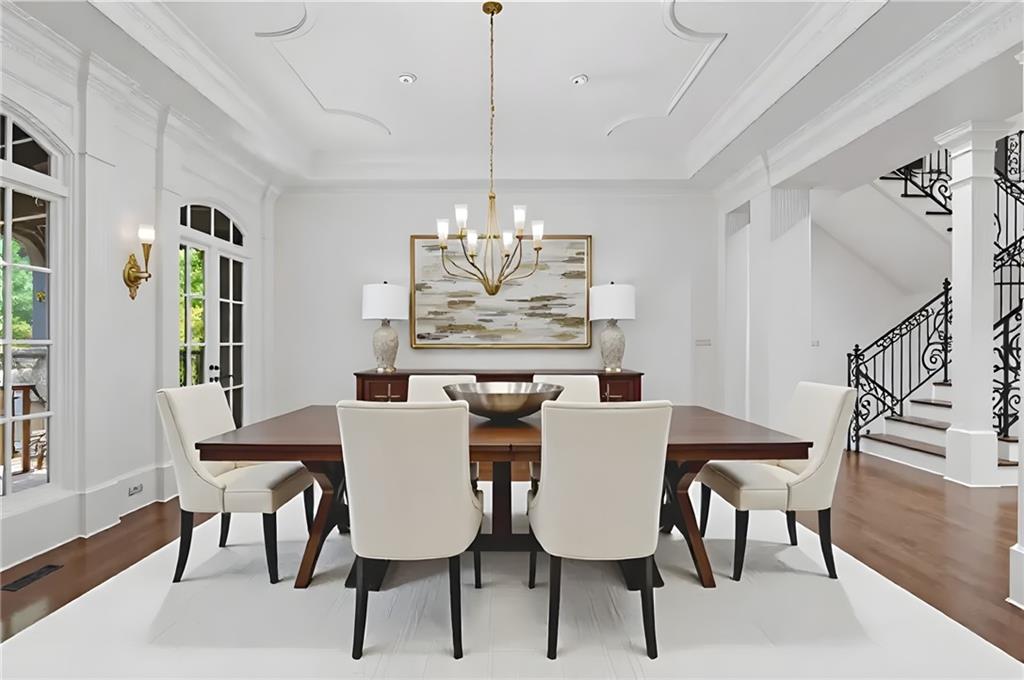 989 Middle Fork Trail Suwanee, GA 30024 - Photo 6 of 76 a view of a dining room with furniture a chandelier and wooden floor