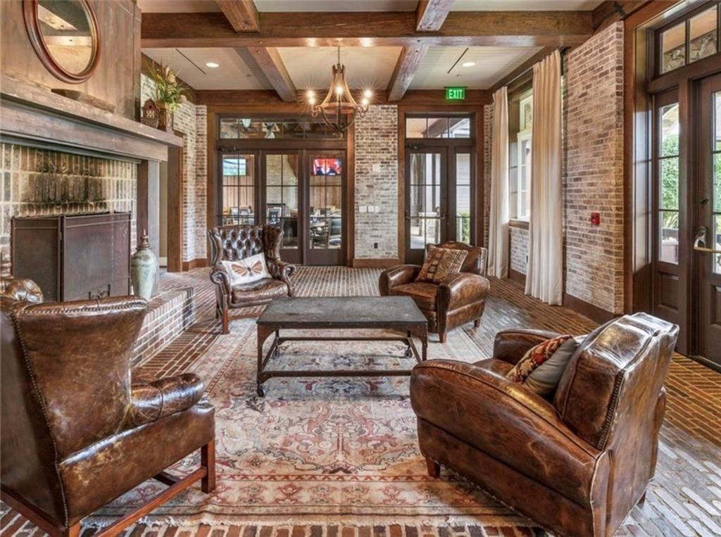 989 Middle Fork Trail Suwanee, GA 30024 - Photo 68 of 76 a living room with furniture a large window and chandelier