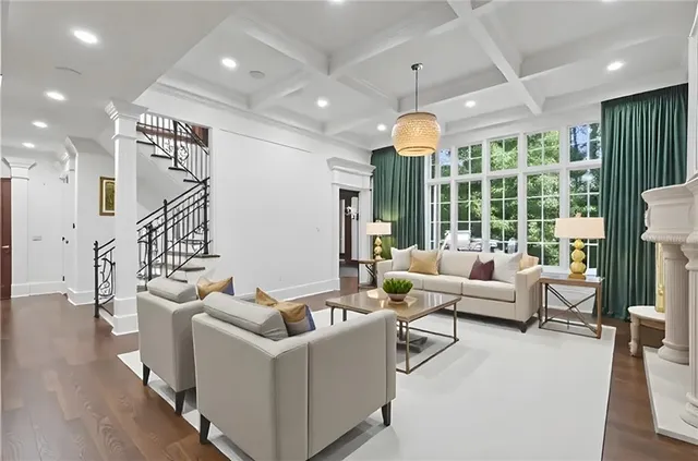 a dining room with furniture a chandelier and wooden floor