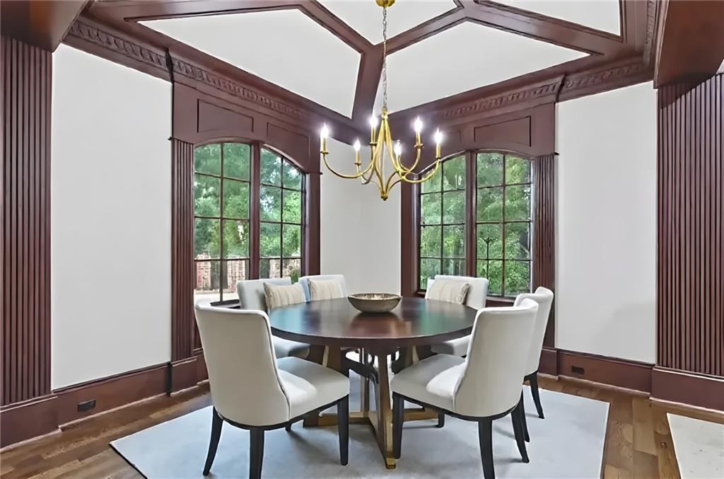 989 Middle Fork Trail Suwanee, GA 30024 - Photo 9 of 76 a dining room with furniture a chandelier and wooden floor