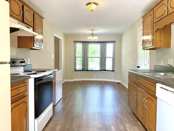 a kitchen with stainless steel appliances granite countertop a stove and a sink