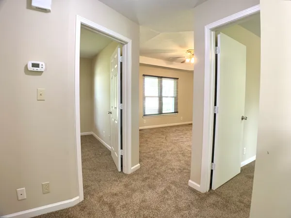 an empty room with windows and closet