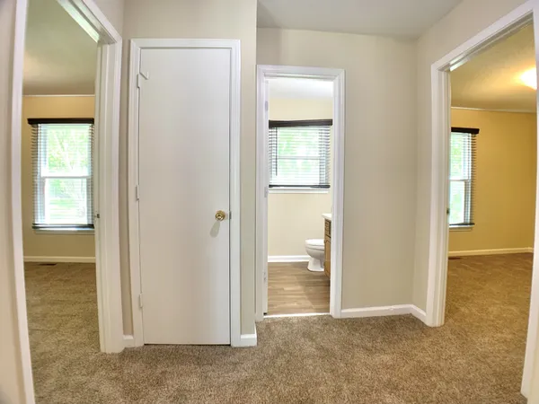 an empty room with windows and closet