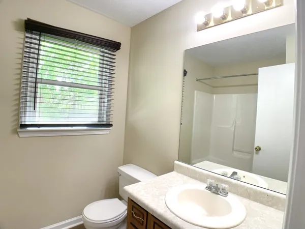 a white bath tub sitting next to a white sink and vanity