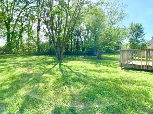 a view of a house with a yard and sitting area