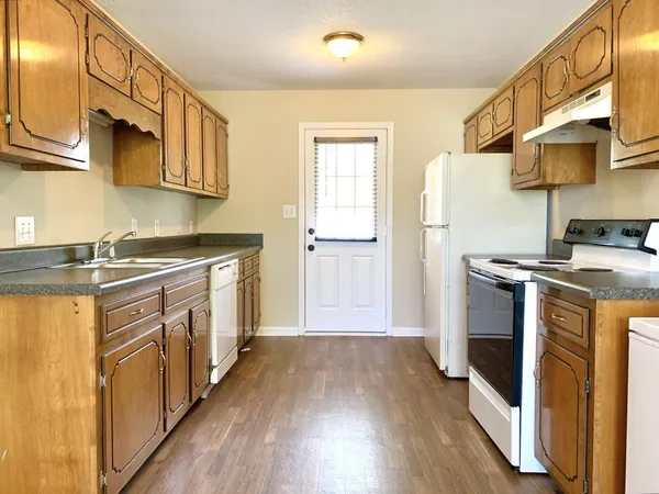 a kitchen with stainless steel appliances a stove a sink and a refrigerator