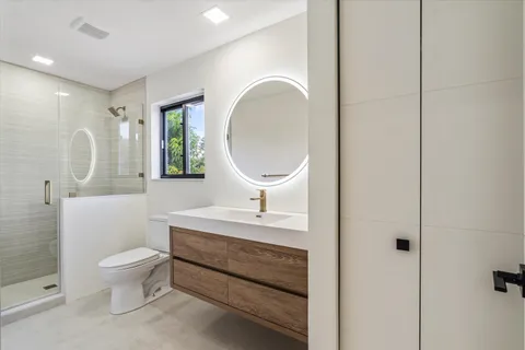 a bathroom with a toilet sink and mirror