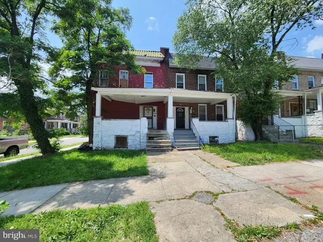 a front view of a house with a yard and a garage