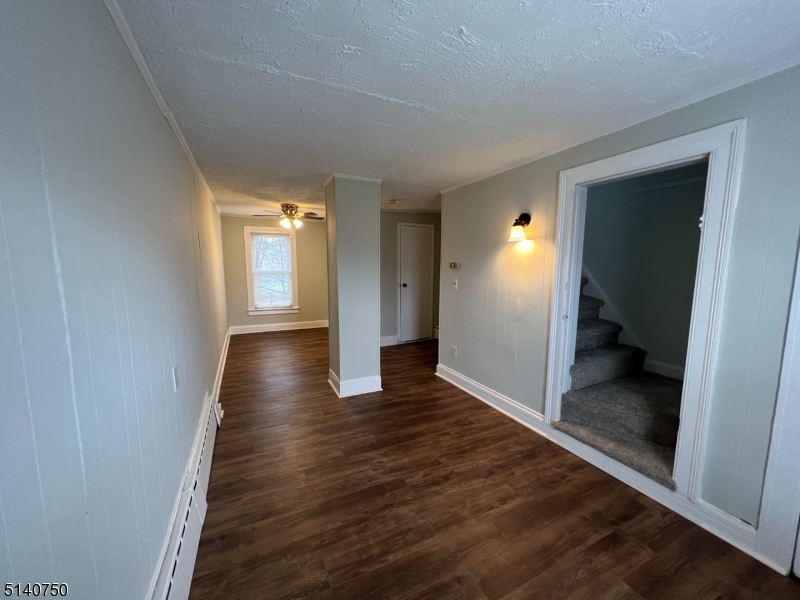 193 Forest Street, Unit 1 Montclair, NJ 07042 - Photo 13 of 20 a view of a hallway with wooden floor and a living room