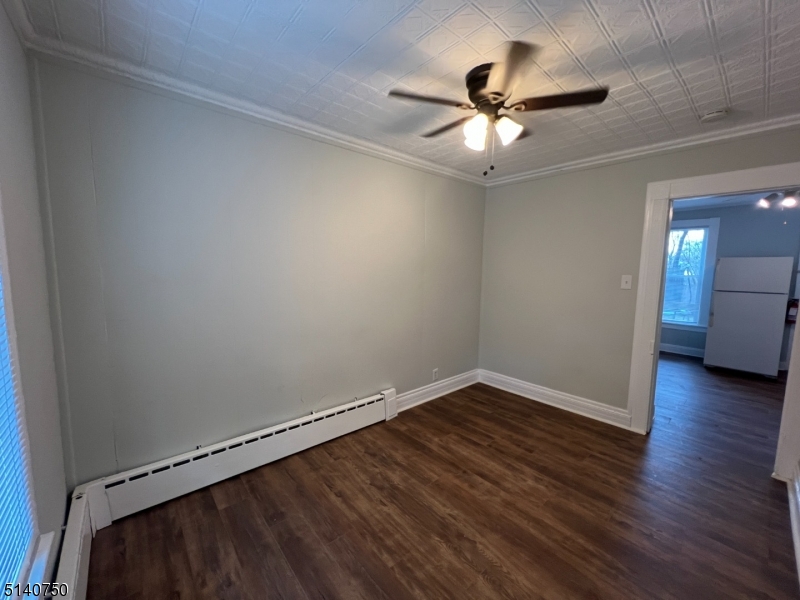 193 Forest Street, Unit 1 Montclair, NJ 07042 - Photo 5 of 20 a view of a room with wooden floor and a ceiling fan